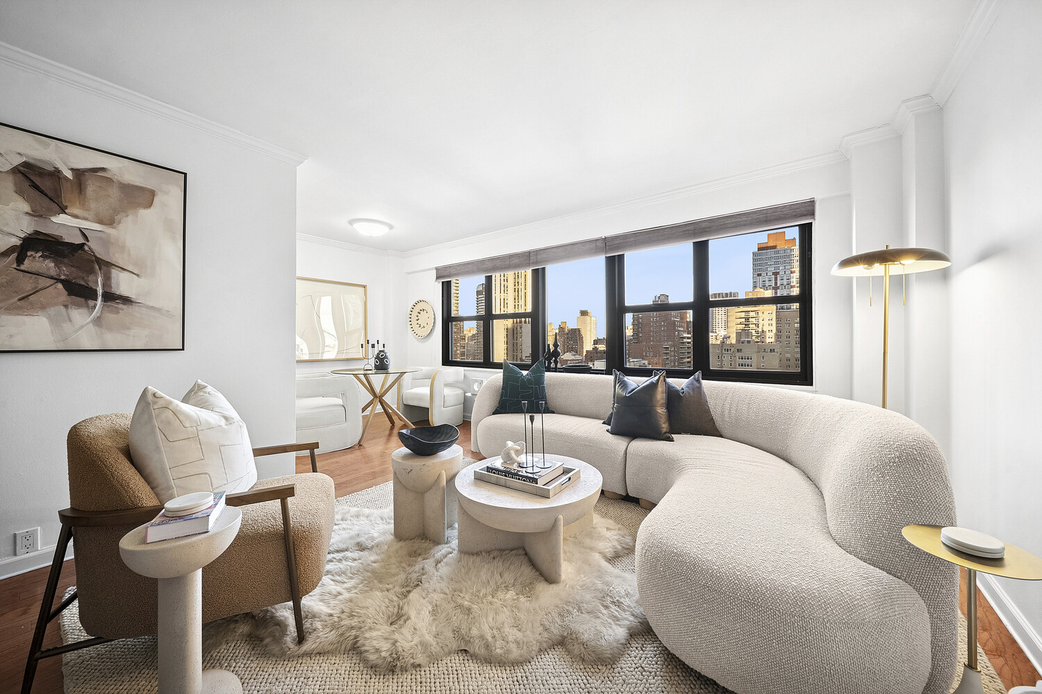 a living room with furniture and a floor to ceiling window