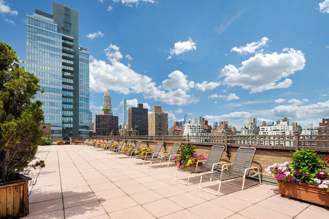 240 East 76th Street, Unit 14G Manhattan, NY 10021 - Photo 6 of 7 a view of a patio with couches and potted plants with sky view
