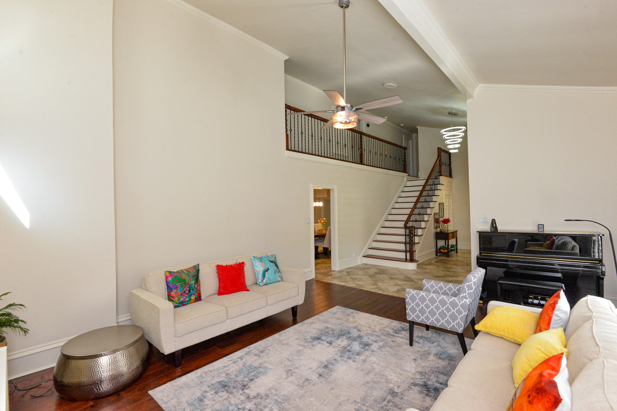 10710 D-K Ranch Road Austin, TX 78759 - Photo 4 of 34 A spacious common area boasts rich hardwood flooring and a prominent staircase leading to the upper level.