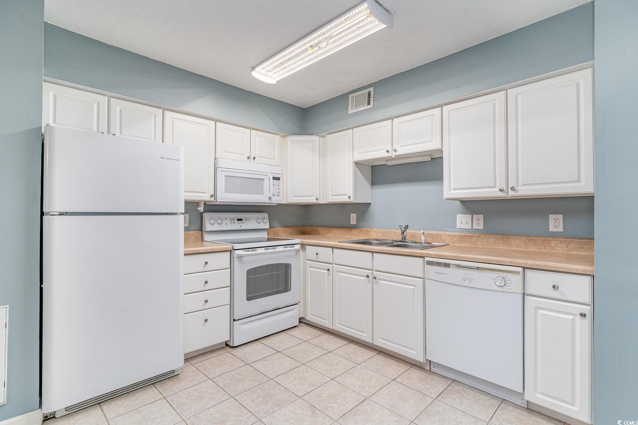 416 Cambridge Circle, Unit H3 Murrells Inlet, SC 29576 - Photo 6 of 15 Kitchen with white cabinetry, light tile patterned