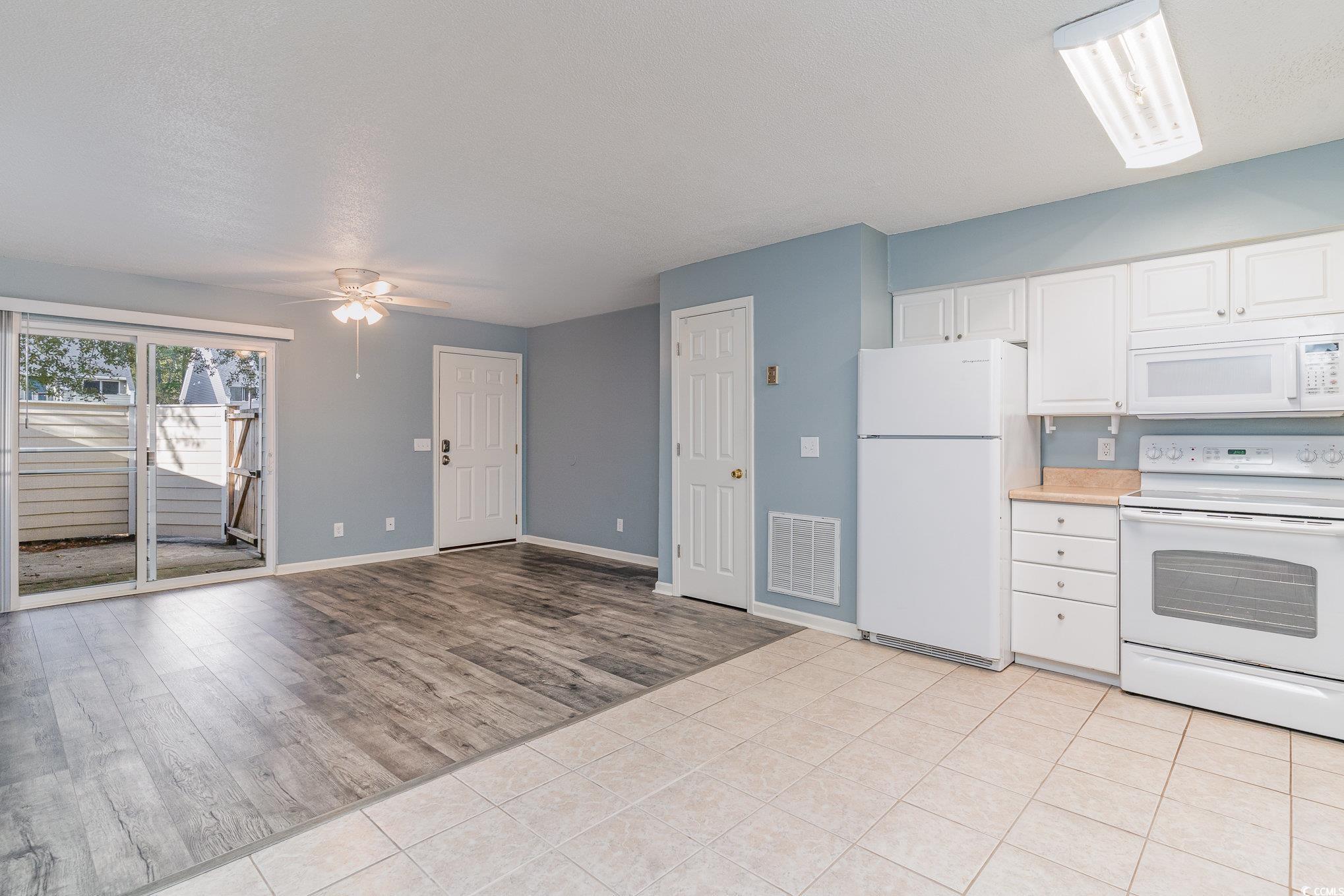 416 Cambridge Circle, Unit H3 Murrells Inlet, SC 29576 - Photo 7 of 15 Kitchen featuring white appliances, white cabinets