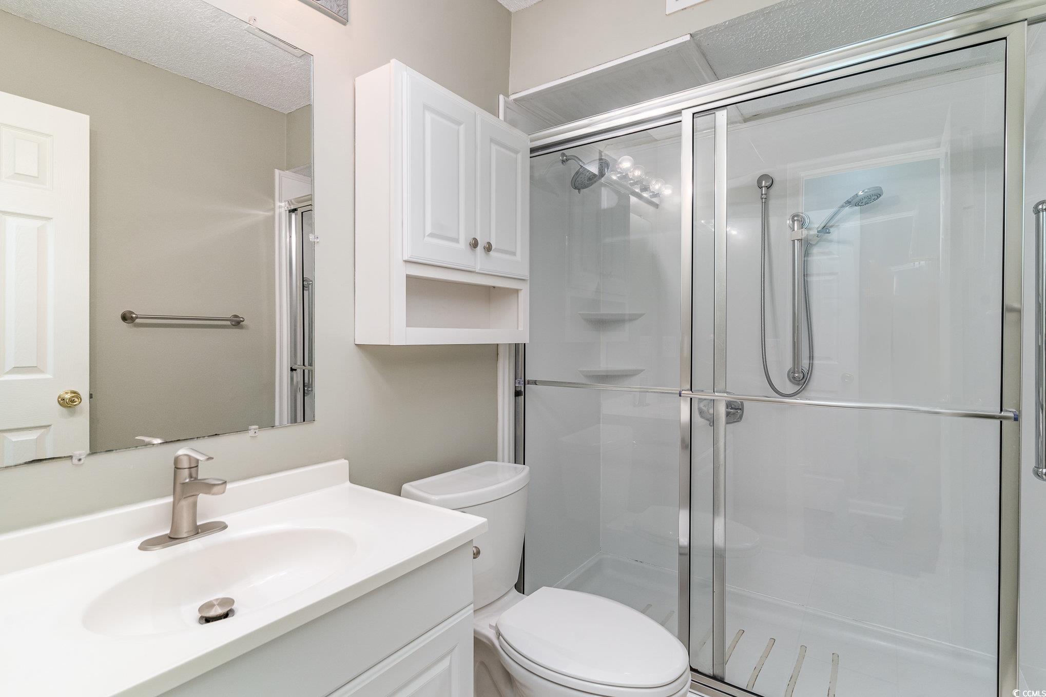416 Cambridge Circle, Unit H3 Murrells Inlet, SC 29576 - Photo 10 of 15 Bathroom featuring toilet, vanity, and walk in sho