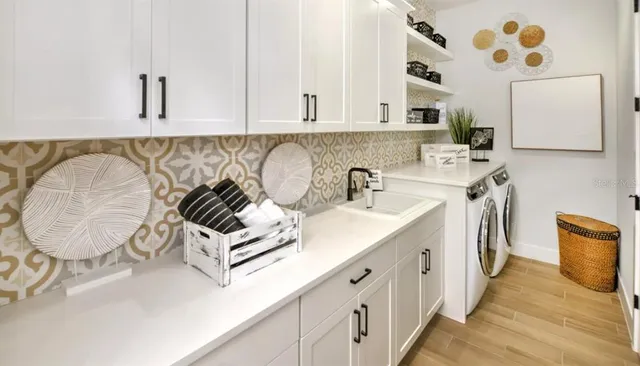 a kitchen with stainless steel appliances a sink a stove and a wooden floors