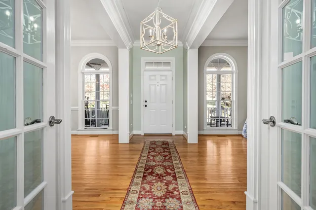 a spacious bedroom with a bed and wooden floor