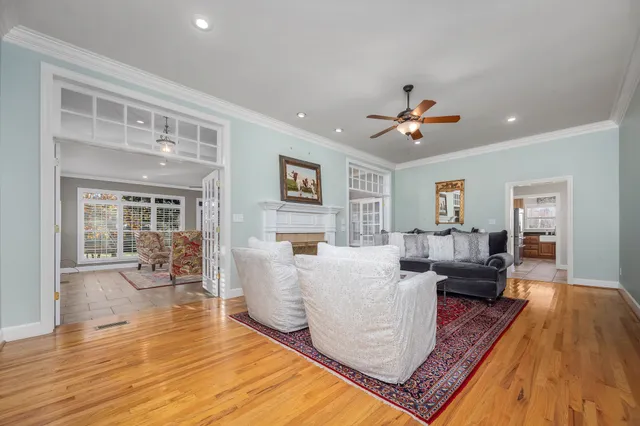 a view of a hallway with wooden floor and entryway