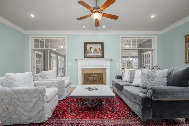 a bedroom with a large bed chandelier and a window