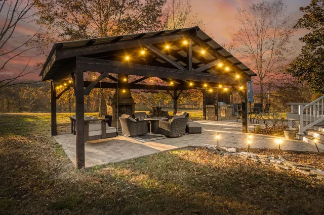 a view of a patio with table and chairs and floor to ceiling window with wooden fence
