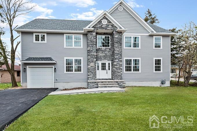 1214 Brookside Road Piscataway, NJ 08854 - Photo 1 of 26 a front view of a house with a garden and yard