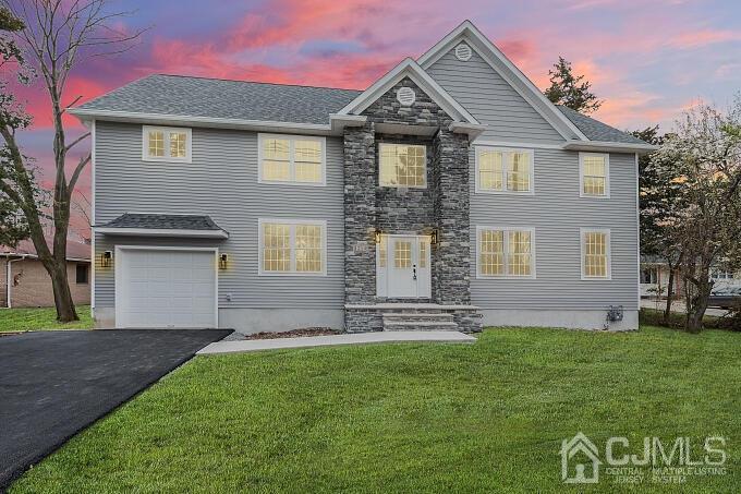 1214 Brookside Road Piscataway, NJ 08854 - Photo 2 of 26 a front view of a house with a garden