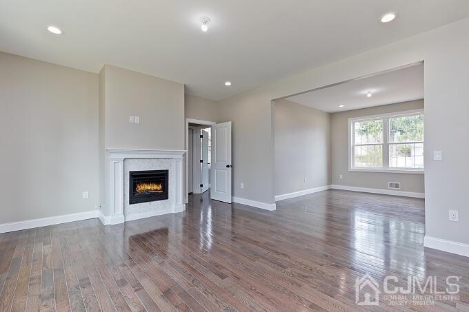 1214 Brookside Road Piscataway, NJ 08854 - Photo 12 of 26 a view of empty room with wooden floor and fireplace