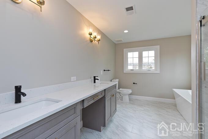 1214 Brookside Road Piscataway, NJ 08854 - Photo 17 of 26 a view of bathroom with a sink mirror and toilet