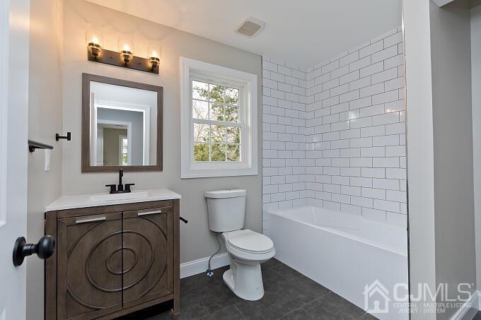 1214 Brookside Road Piscataway, NJ 08854 - Photo 22 of 26 a bathroom with a toilet sink and mirror