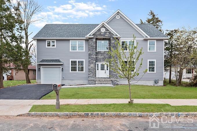 1214 Brookside Road Piscataway, NJ 08854 - Photo 24 of 26 a front view of a house with a yard and garage