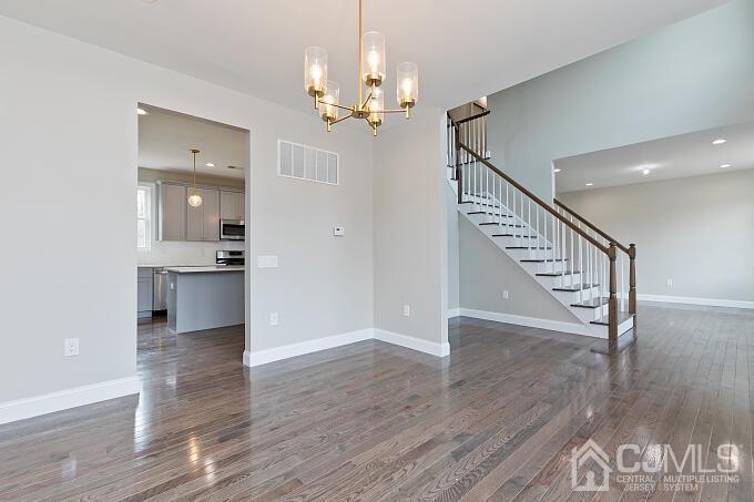 1214 Brookside Road Piscataway, NJ 08854 - Photo 5 of 26 a view of a hallway with wooden floor and a kitchen