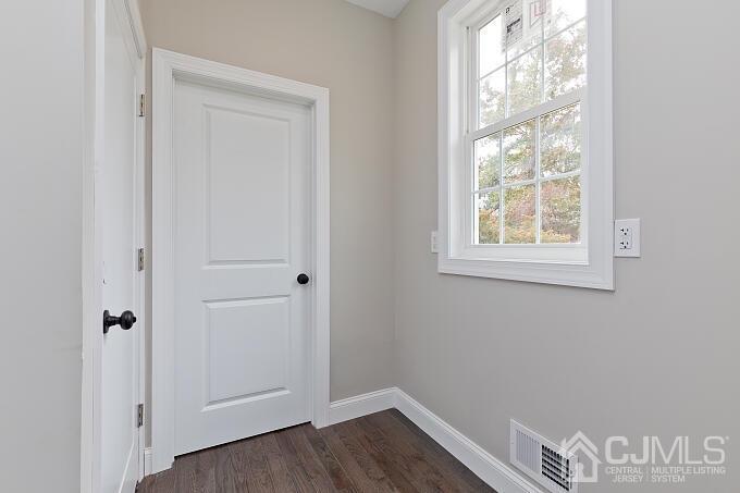 1214 Brookside Road Piscataway, NJ 08854 - Photo 8 of 26 a view of an empty room with wooden floor and a window