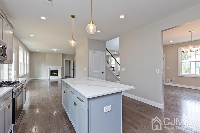 1214 Brookside Road Piscataway, NJ 08854 - Photo 10 of 26 a kitchen with a stove a sink a refrigerator and a view of living room