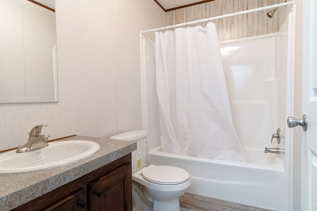 1944 Red Cut Road Chatsworth, GA 30705 - Photo 16 of 17 a bathroom with a granite countertop sink toilet and a bathtub