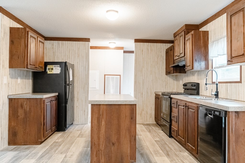 1944 Red Cut Road Chatsworth, GA 30705 - Photo 5 of 17 a kitchen with stainless steel appliances granite countertop a refrigerator a stove top oven a sink and dishwasher