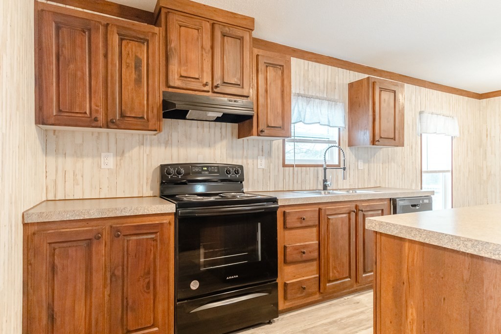 1944 Red Cut Road Chatsworth, GA 30705 - Photo 6 of 17 a kitchen with stainless steel appliances granite countertop a stove a sink and a microwave
