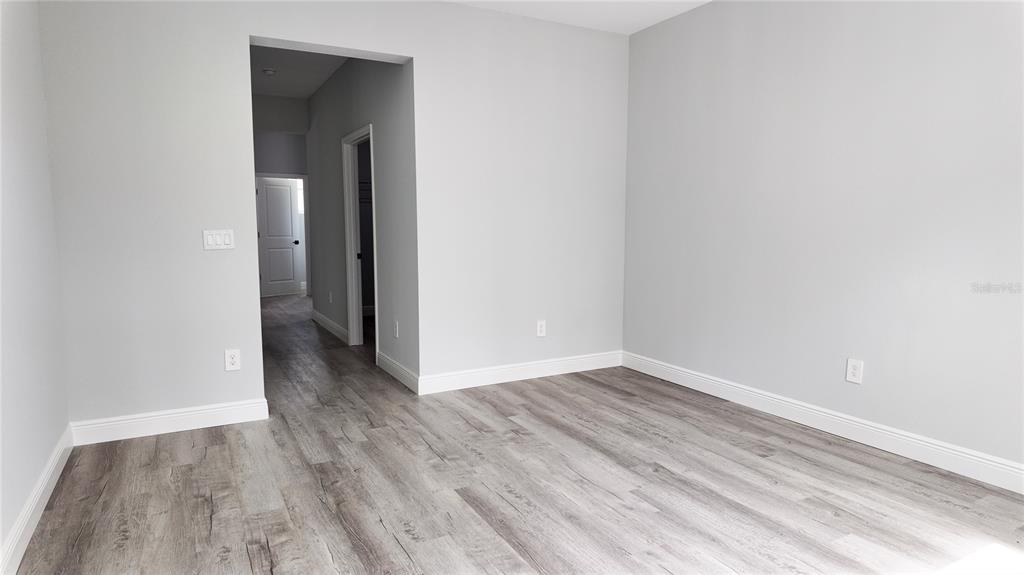 7 Spring Pass Ocala, FL 34472 - Photo 19 of 35 an empty room with wooden floor and entrance