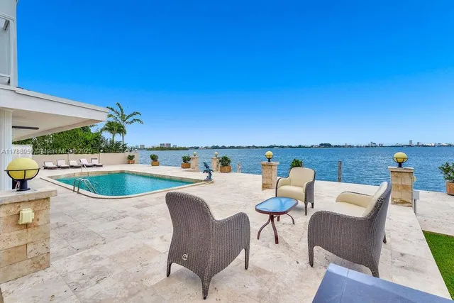 a view of a swimming pool with lounge chairs