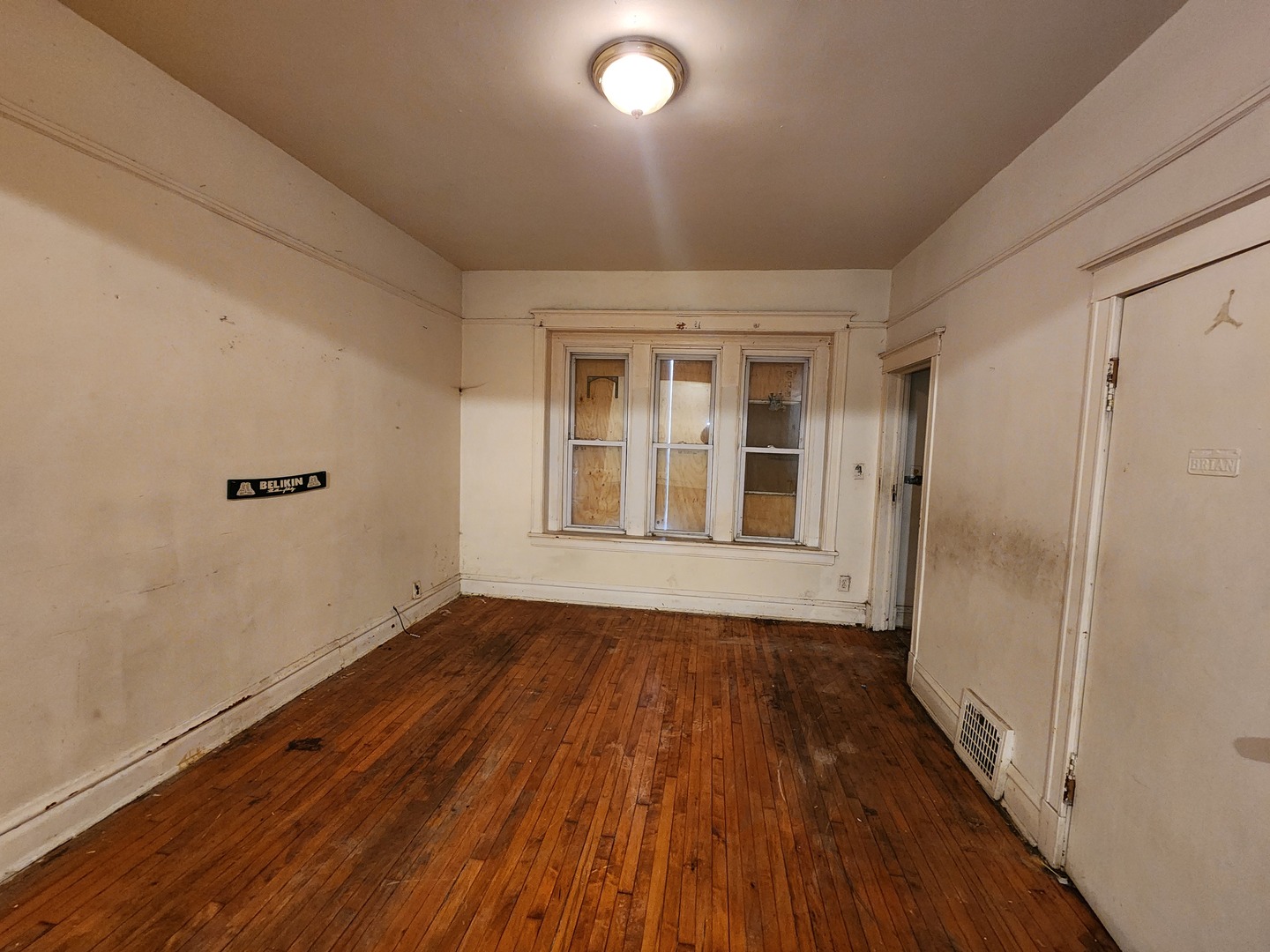 5242 South Sangamon Street Chicago, IL 60609 - Photo 3 of 14 a view of an empty room with wooden floor and a window