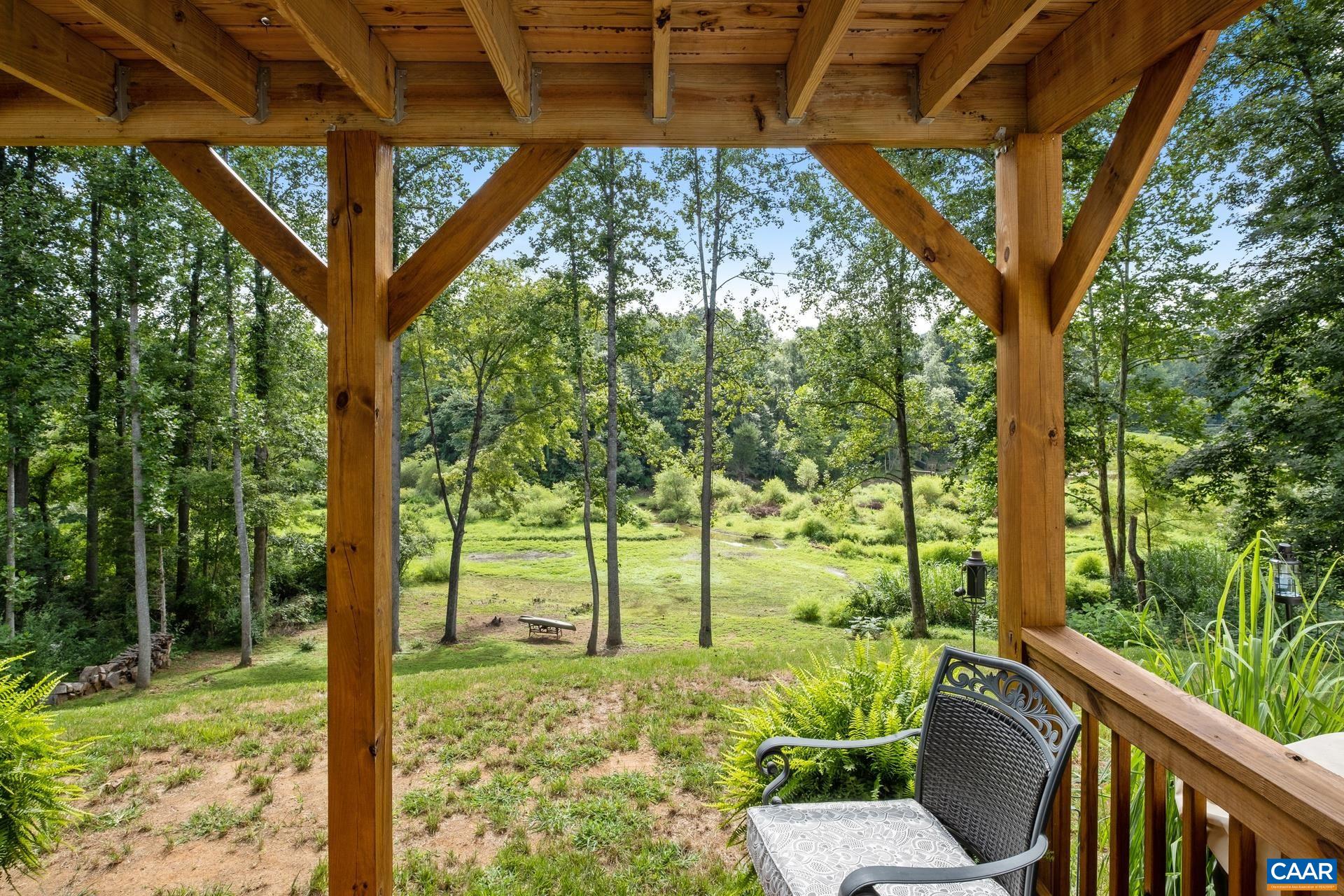 283 Logtrac Road Stanardsville, VA 22973 - Photo 37 of 49 a view of backyard with large trees and plants