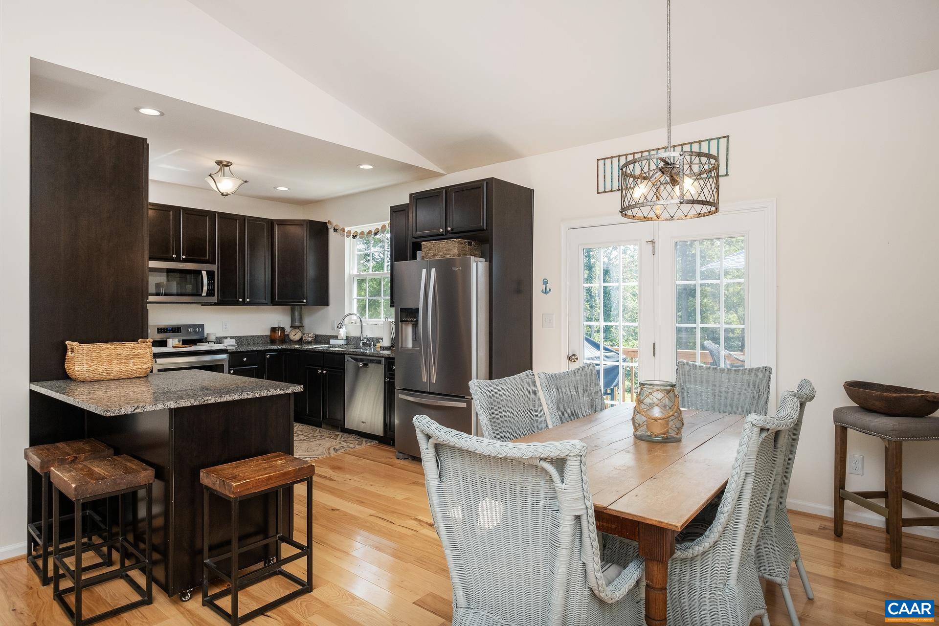 283 Logtrac Road Stanardsville, VA 22973 - Photo 9 of 49 a kitchen with refrigerator cabinets dining table and chairs
