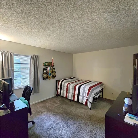 a bedroom with a bed and a desk