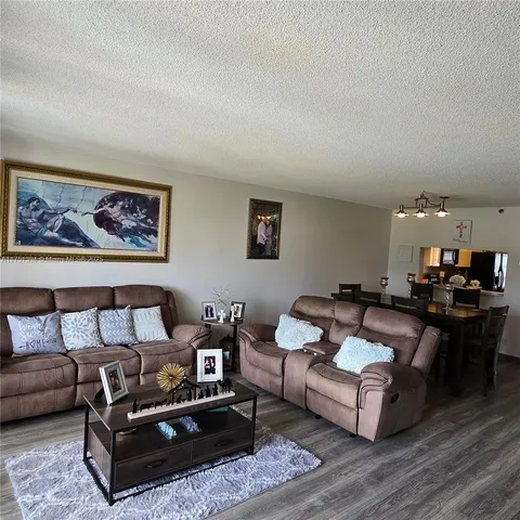 a living room with furniture a rug and a table