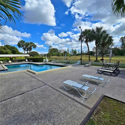 a view of a street with a large tree