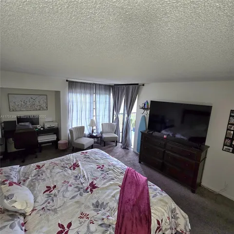 a bedroom with a bed and glass window