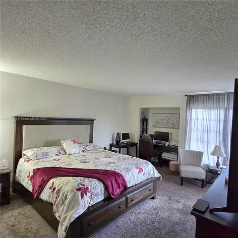 a bedroom with bed and a couch