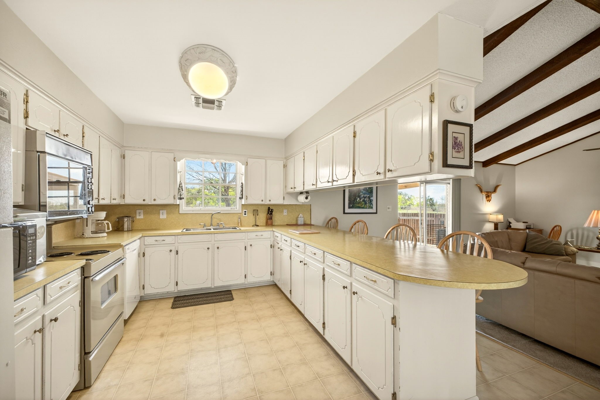 212 Halstedt Road La Grange, TX 78945 - Photo 10 of 40 a kitchen with sink cabinets and window