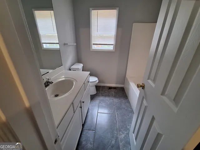 a bathroom with sink and mirror