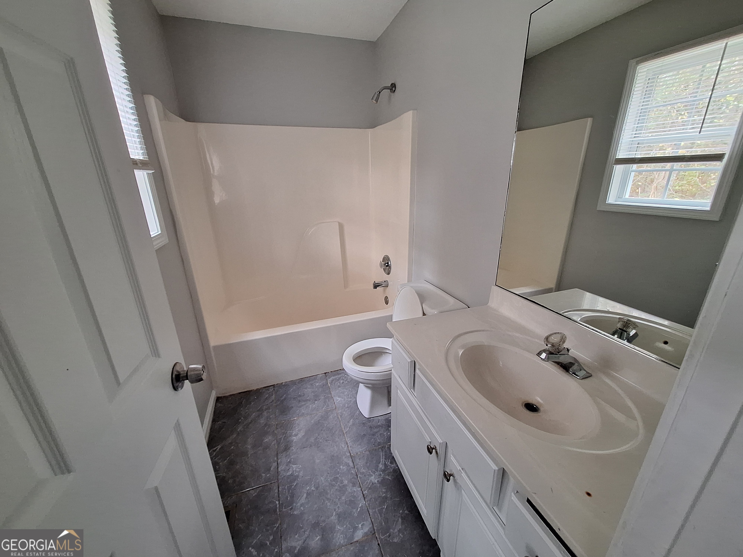 5633 Rutland Drive Southwest Powder Springs, GA 30127 - Photo 9 of 11 a bathroom with a sink a toilet and a bathtub