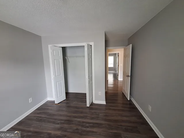 a view of hallway with wooden floor