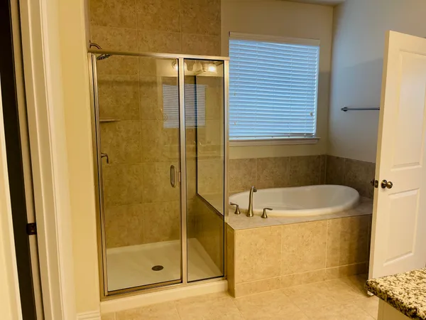a bathroom with a bathtub and a shower