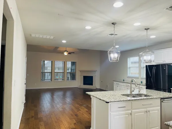 a view of a kitchen with a sink and a large mirror