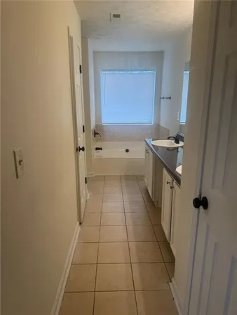 a bathroom with a granite countertop sink a toilet and a mirror