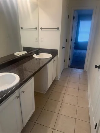 a kitchen with a sink a counter top space and cabinets