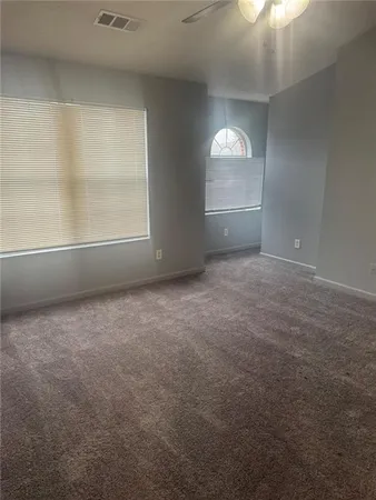 an empty room with windows and brick walls