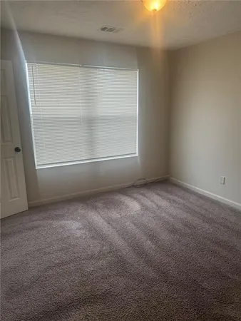 an empty room with a empty space and window