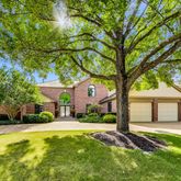 a front view of a house with a yard table and chairs