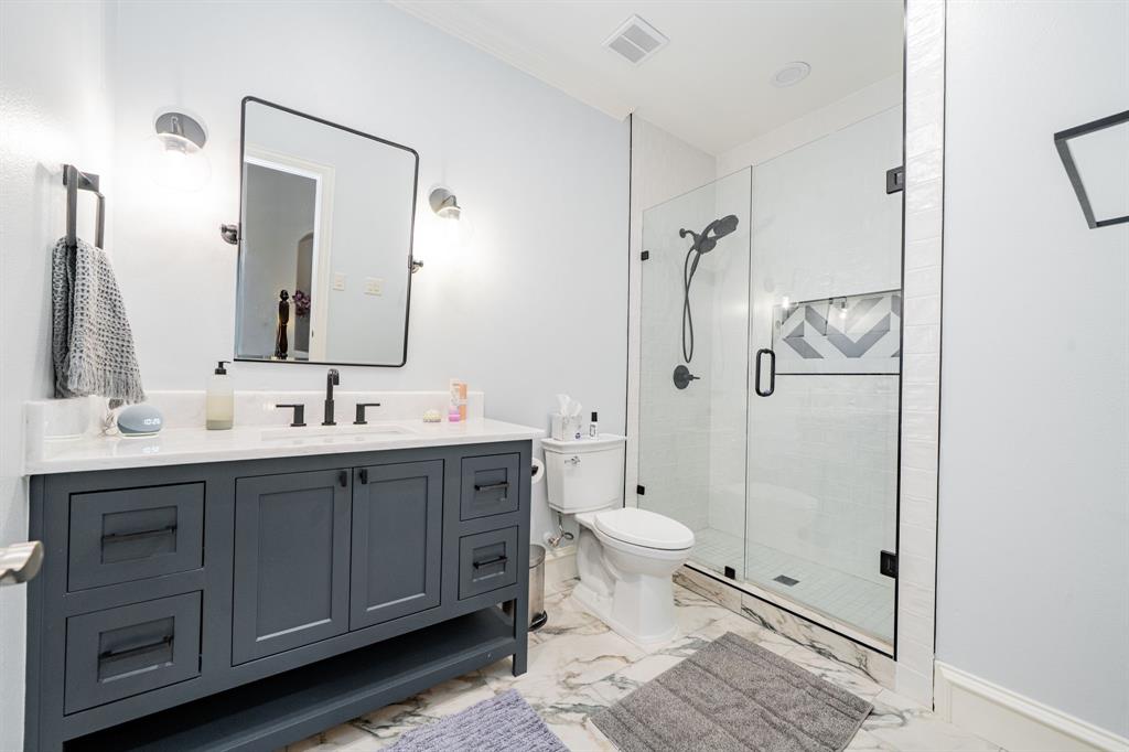 5517 Longview Street Dallas, TX 75206 - Photo 17 of 33 a bathroom with a double vanity sink toilet mirror and shower