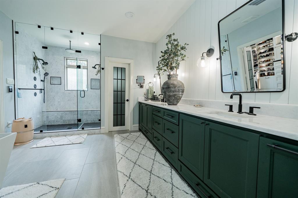 5517 Longview Street Dallas, TX 75206 - Photo 26 of 33 a spacious bathroom with a double vanity sink mirror and shower