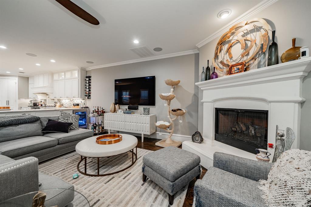 5517 Longview Street Dallas, TX 75206 - Photo 7 of 37 a living room with furniture a fireplace and a flat screen tv