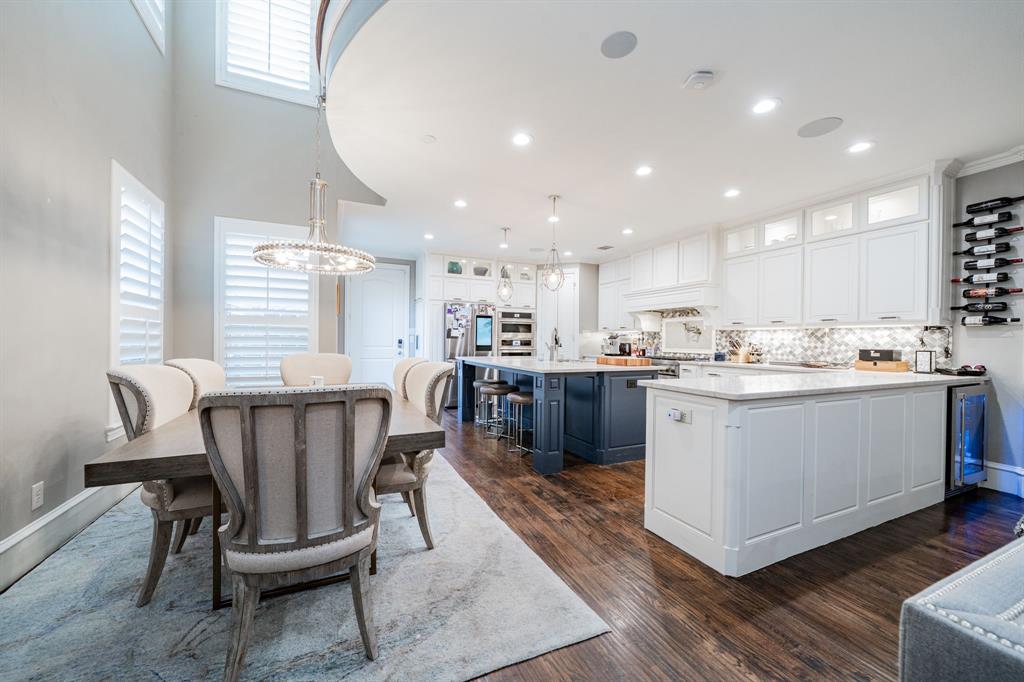 5517 Longview Street Dallas, TX 75206 - Photo 9 of 37 a kitchen with a table chairs wooden floors and a view of living room