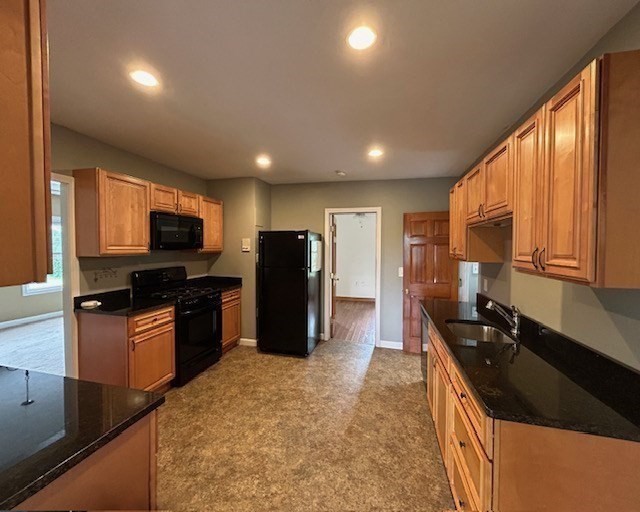 5 Anna Street Worcester, MA 01604 - Photo 3 of 19 a kitchen with stainless steel appliances granite countertop a refrigerator a sink a stove a microwave and wooden cabinets