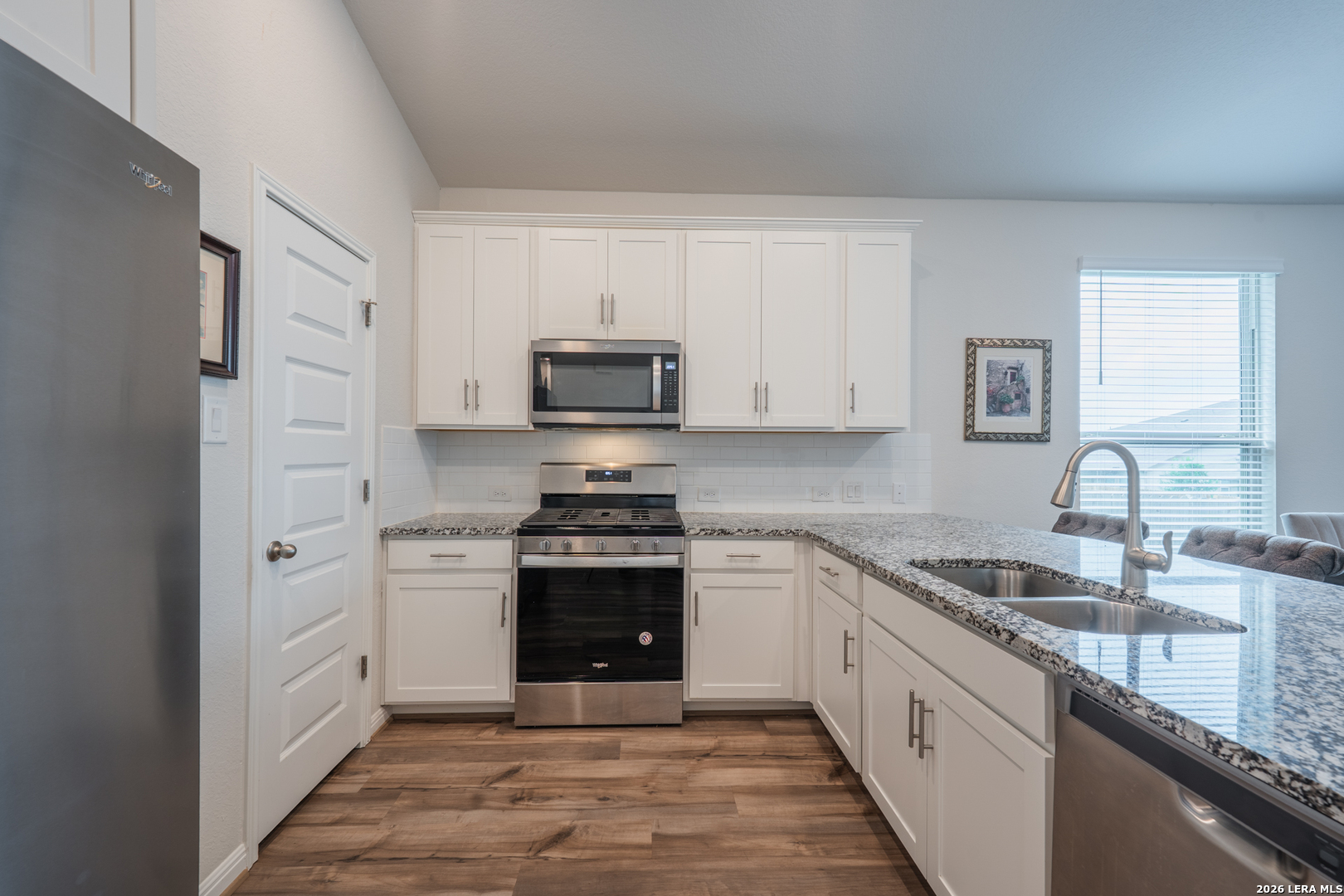 4947 Ranahan Pass St. Hedwig, TX 78152 - Photo 8 of 37 a large kitchen with stainless steel appliances granite countertop a stove a sink dishwasher and a refrigerator
